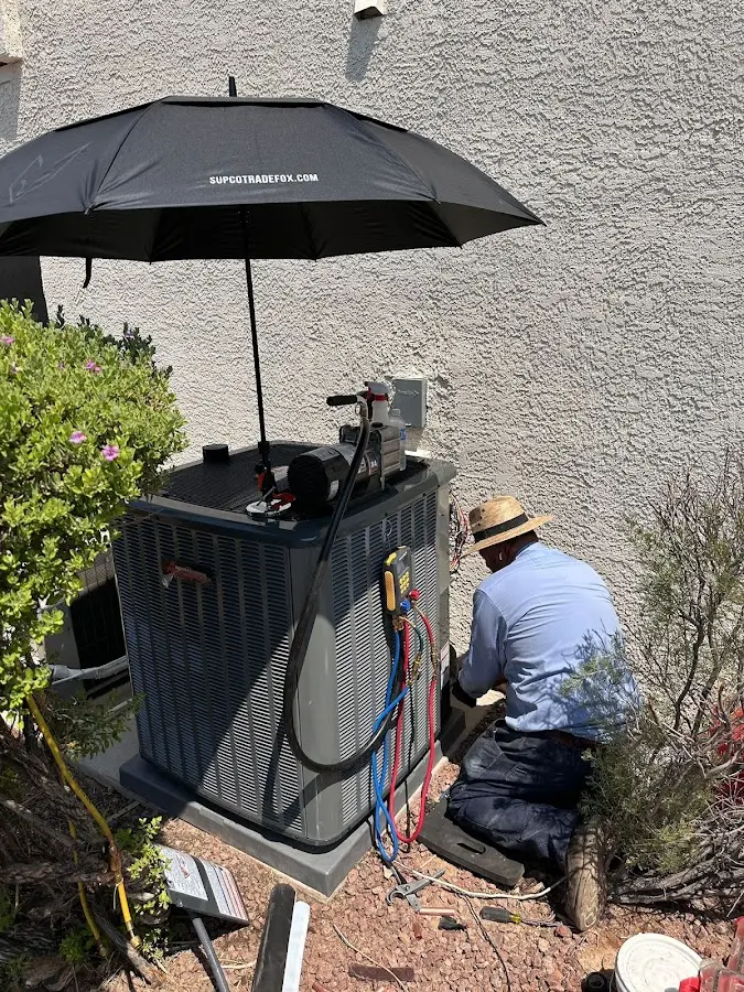 HVAC technician performing outdoor AC maintenance in Youngtown